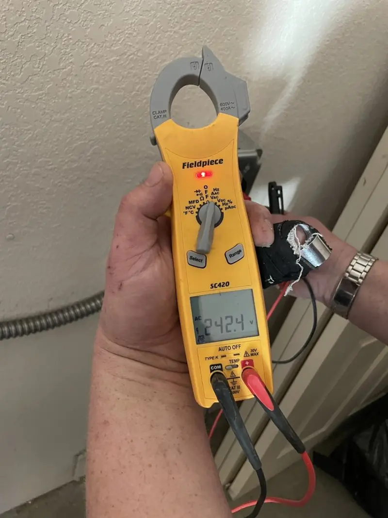 Voltage testing with clamp meter during Outlet Installation in Franklin